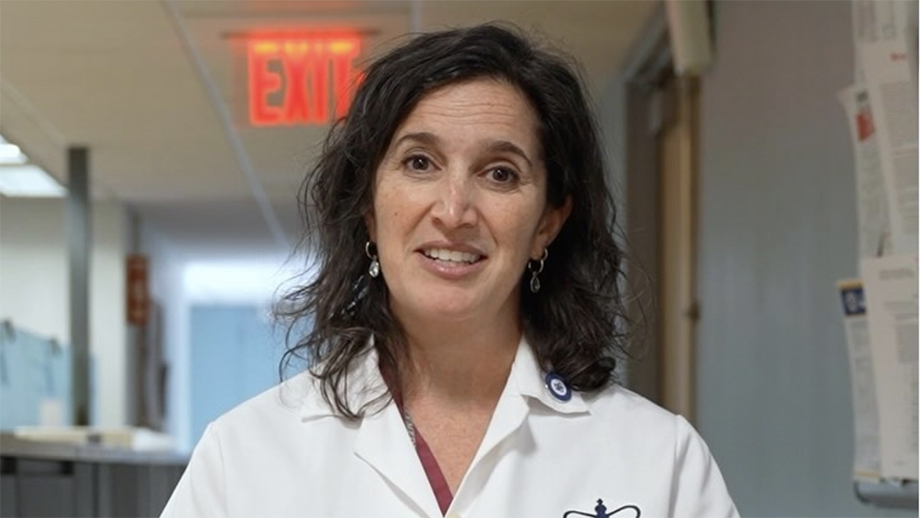 Photograph of Dr. Katherine Fischkoff standing in her Columbia University white coat.