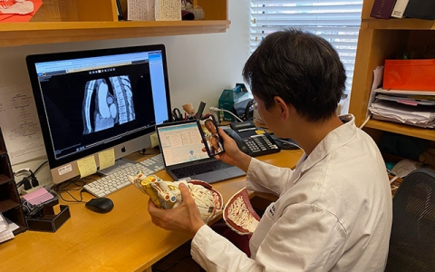 Cardiac surgeon Dr. Takayama prepares for a video visit with a patient. “Many of my patients loved them, especially when they didn’t have to come into the city. It’s very useful.” 