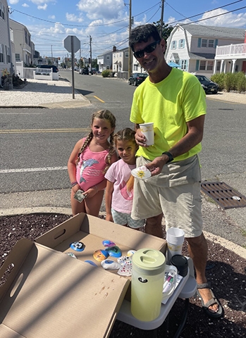 Luisa and her cousin Andie with their first customer, Doug the ice cream man.